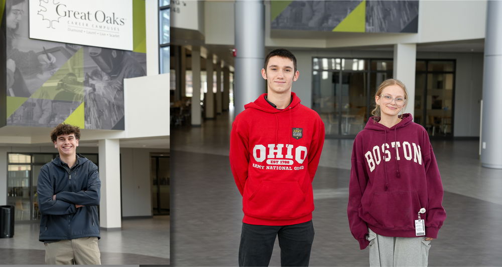 A photo of a make student with their arms crossed underneath a great oaks sign, next to two students wearing red hoodies