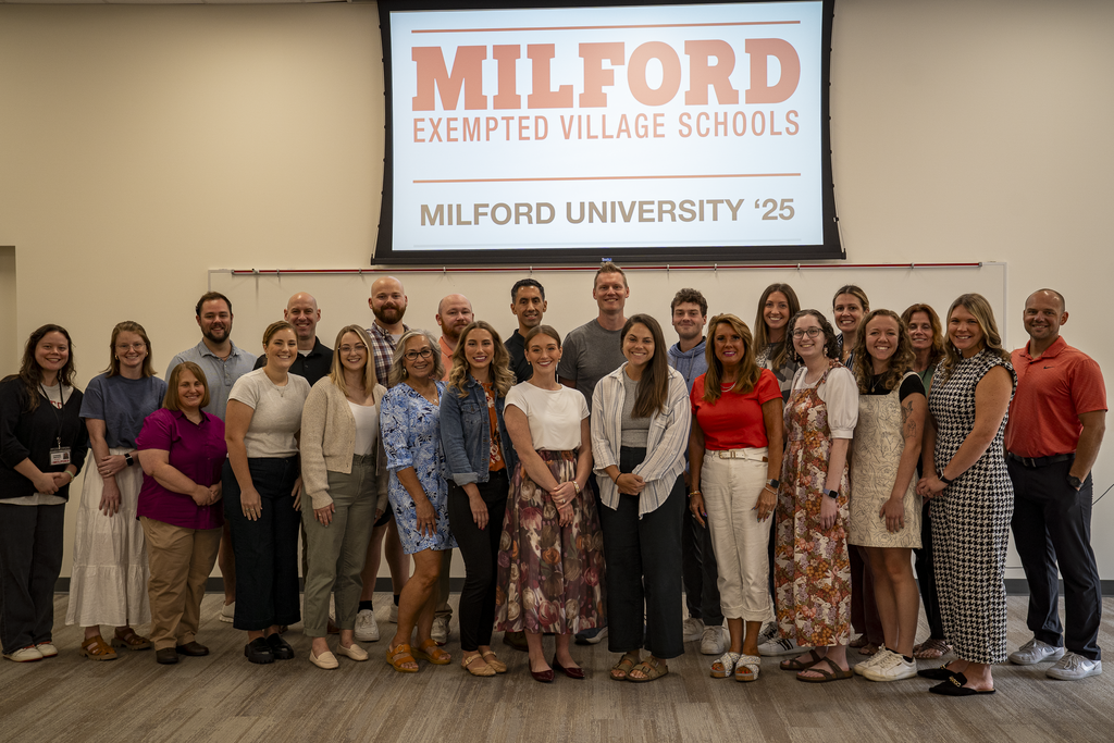 Group Photo of Teachers in front of sign saying Milford University
