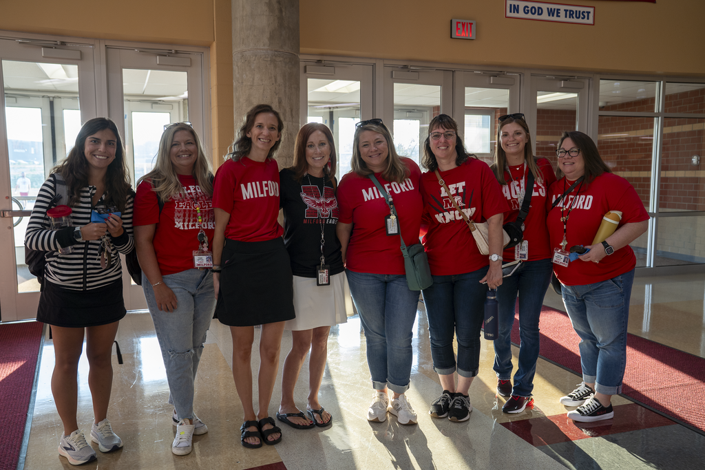 Group of women in red Milford shirts smiling at the camera