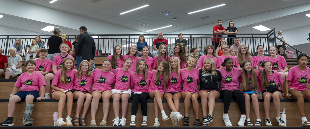 group of girls in pink "WEB" shirts