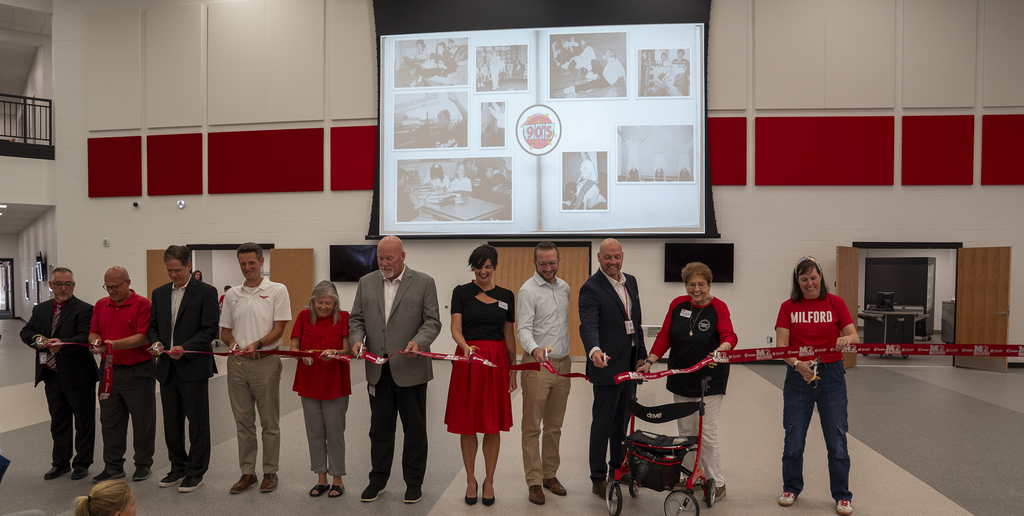 Group of people cutting a ribbon