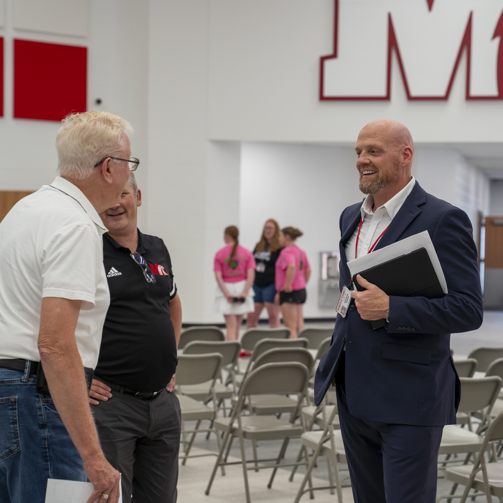 Superintendent Spieser smiling at man with glasses