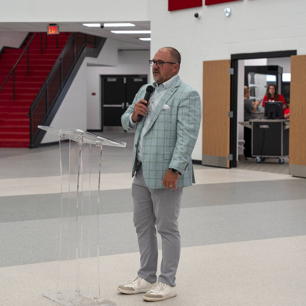 Man in sneakers and blue/green jacket