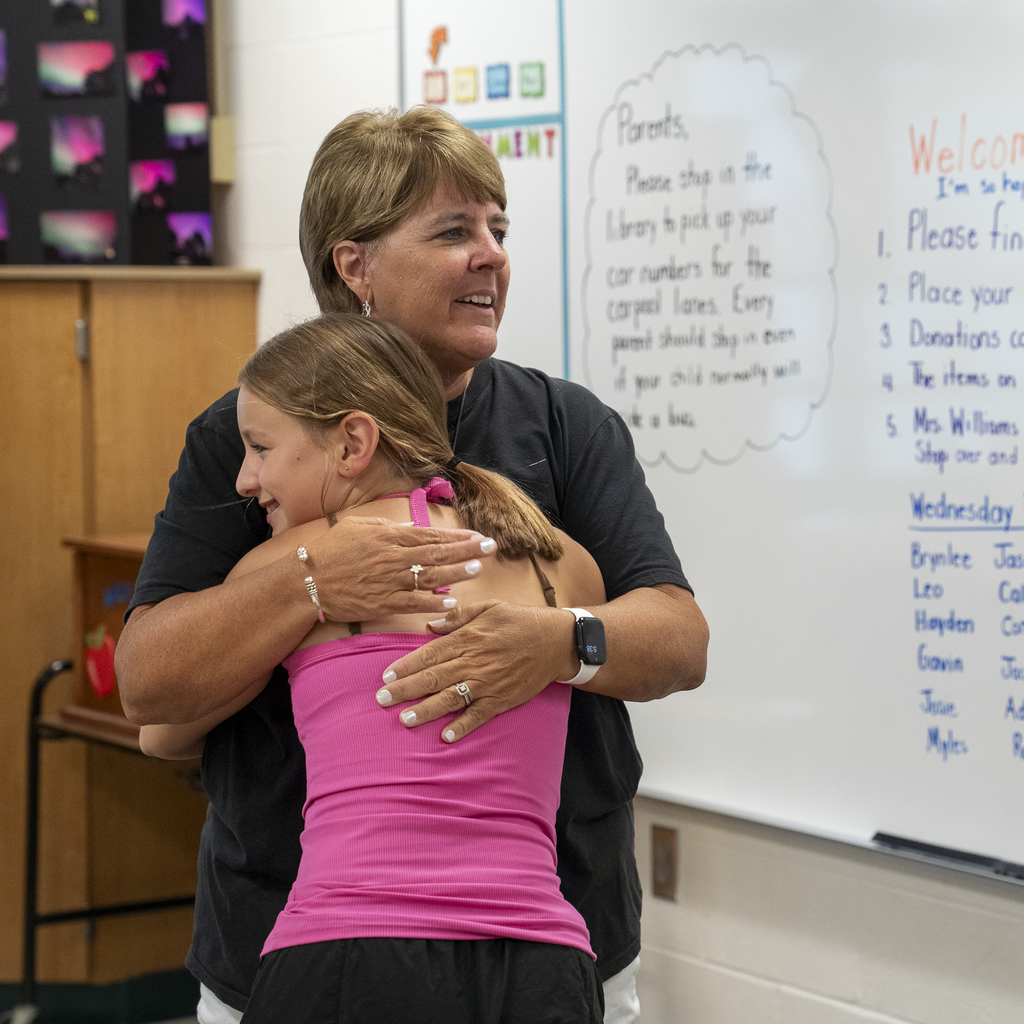 Student hugging a teacher