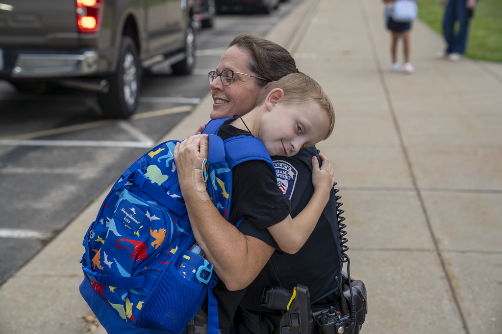 Officer giving a kid a hug