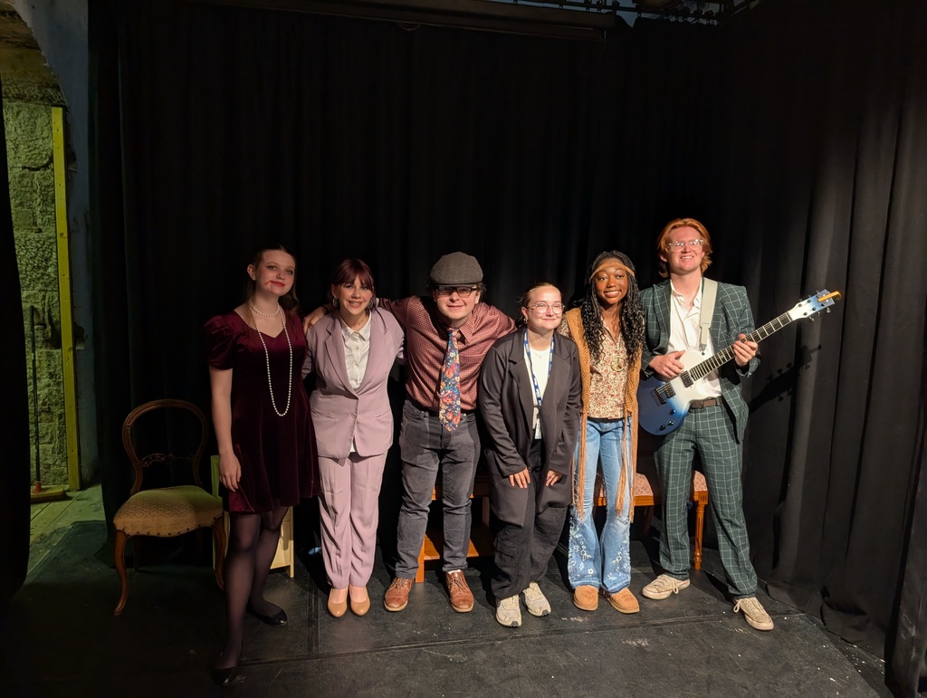 A small group of students in costume on Stage
