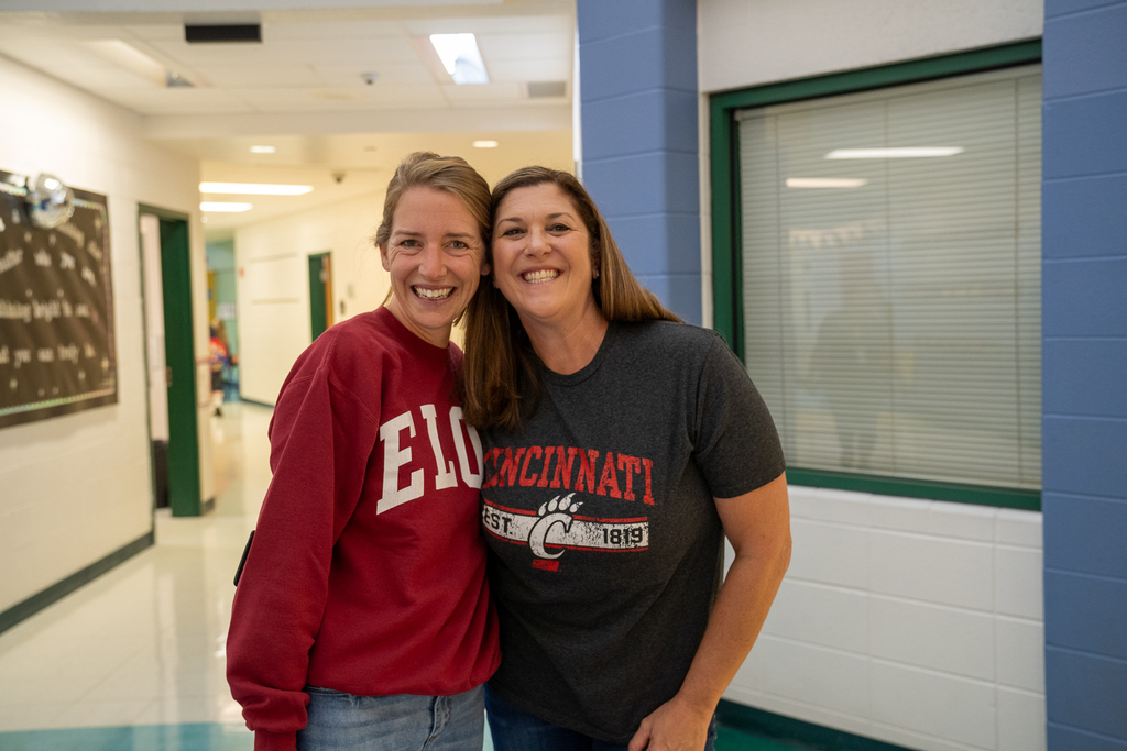 Woman wearing a ELON sweatshirt next to woman in a Cincinnati shirt