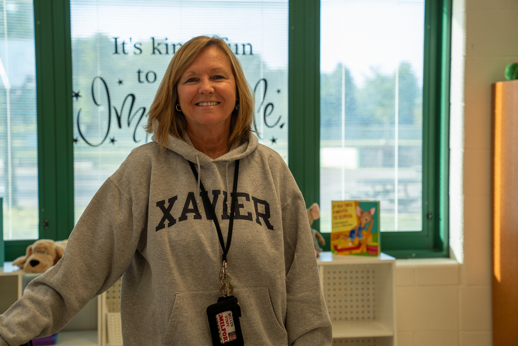 Woman wearing a XAVIER hoodie