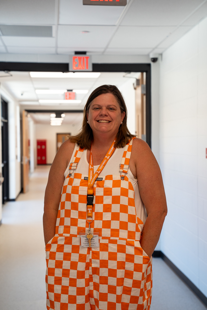 Woman in orange checkered overalls