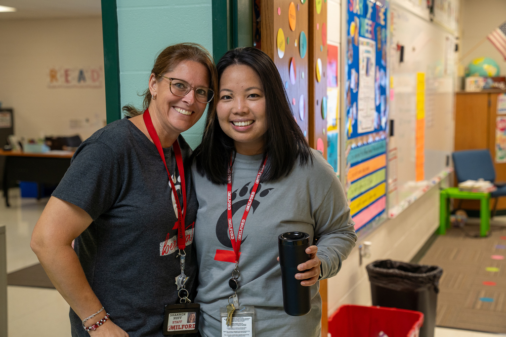 Two women wearing UC shirts