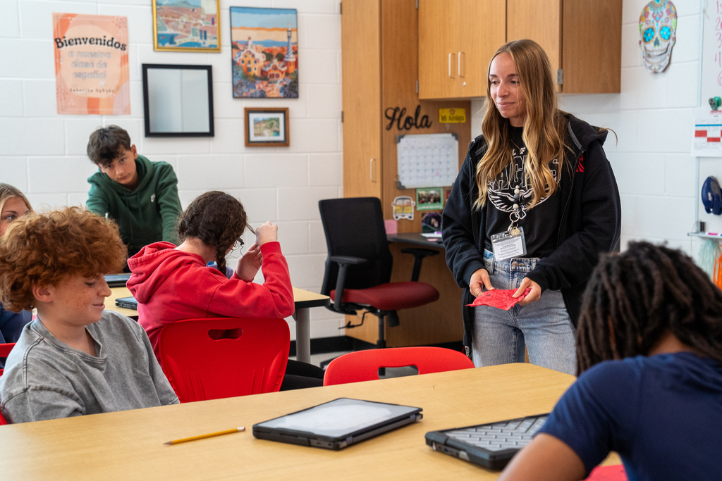 Female teacher smiling at red headed boy