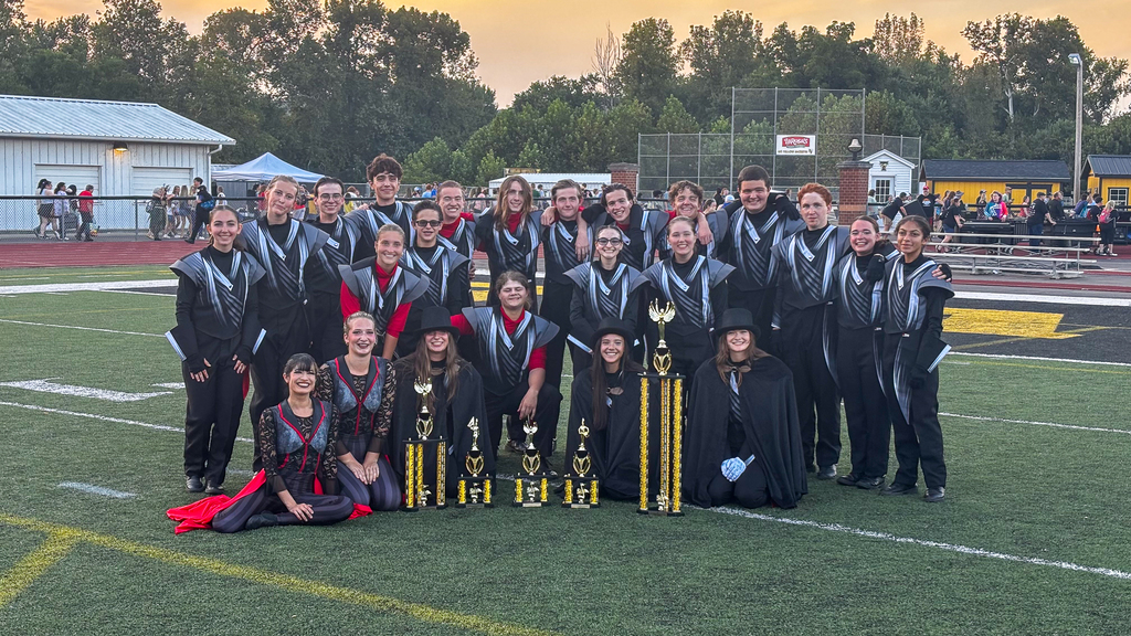 Group of band members with  trophies 