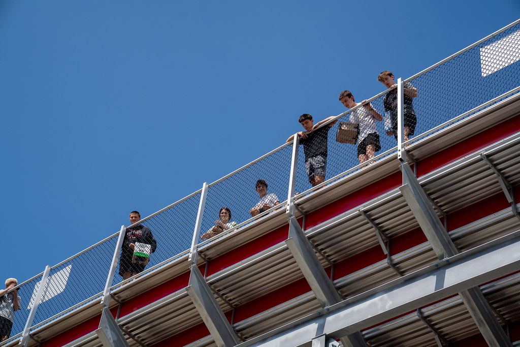Students high in the bleachers looking down