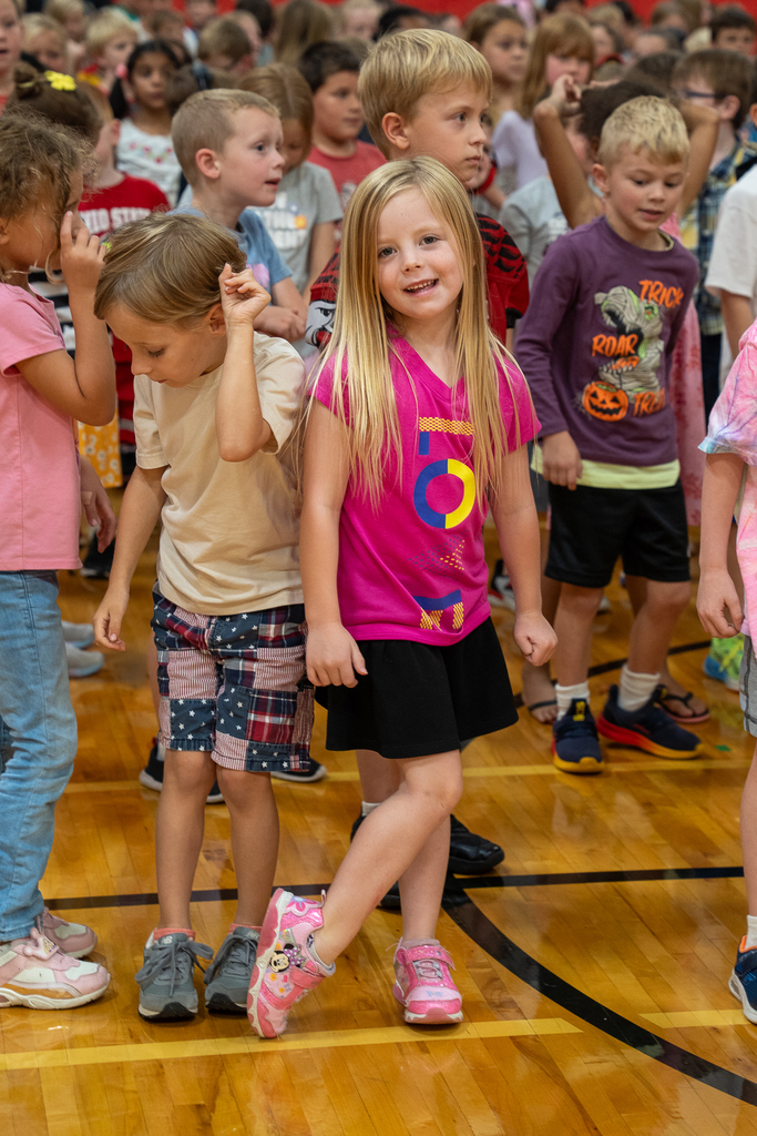 a girl in pink smiling at the camera