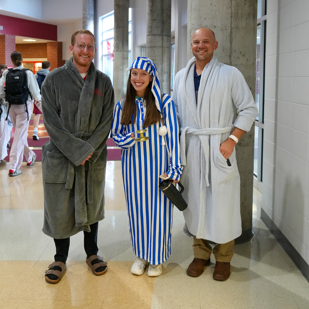 (Left to right) a man with glasses in a grey robe, a girl in a blue stripped Pj set and bald man with a white robe
