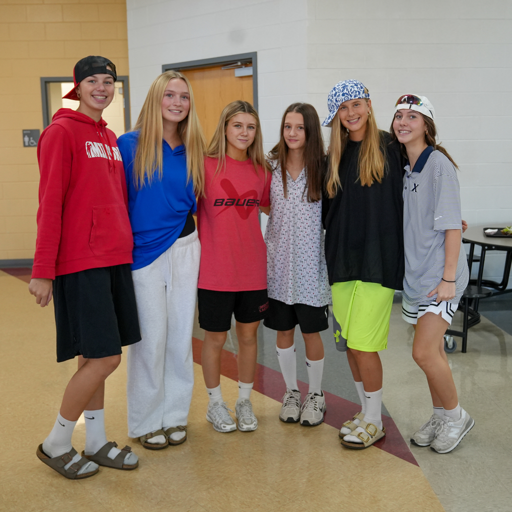 Group of girls wearing oversized shirts and baggy gym shorts 