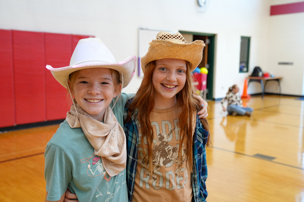 Two young girls wearing cowboy hats