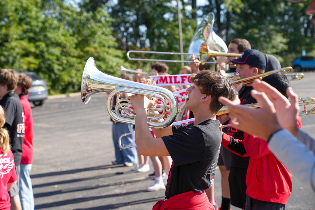 A student playing a french horn