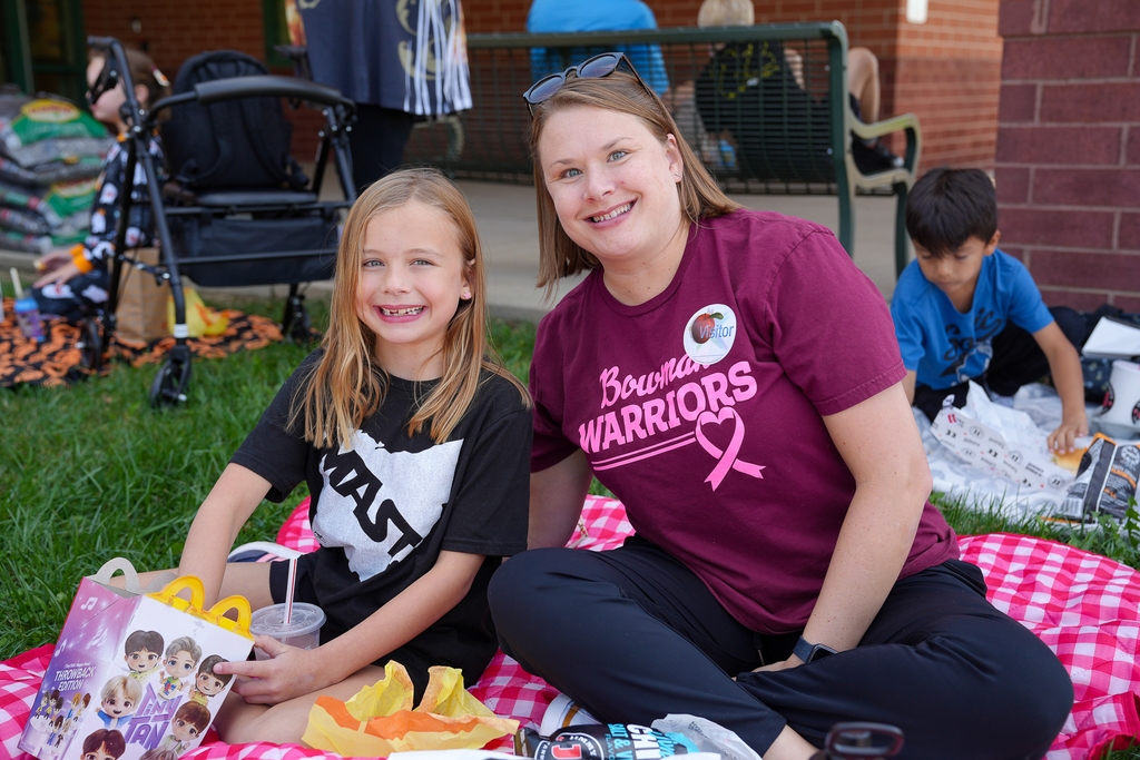 A woman and daughter smiling