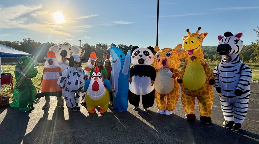 a bunch of blow up costumes standing in a row