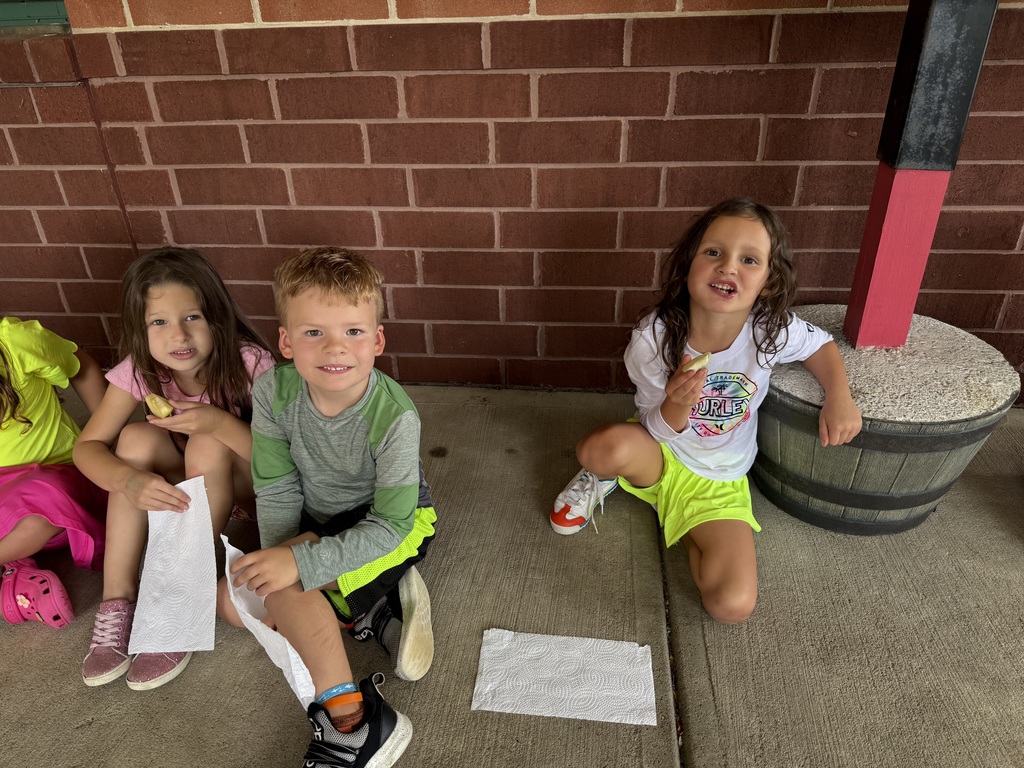 Three students smiling at the camera
