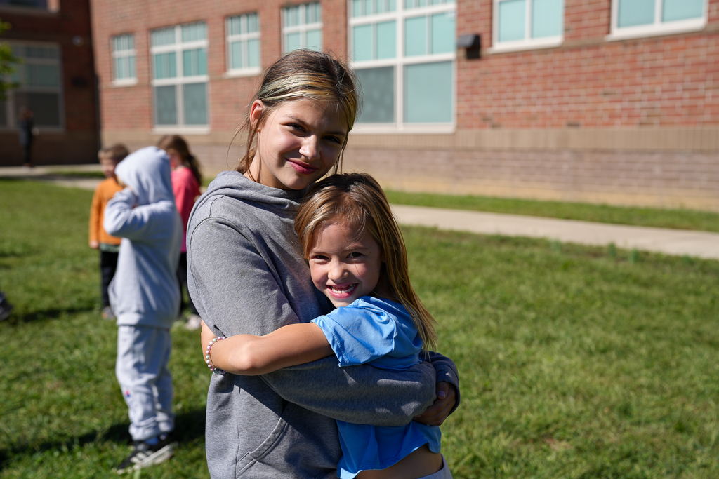 Two girls hugging