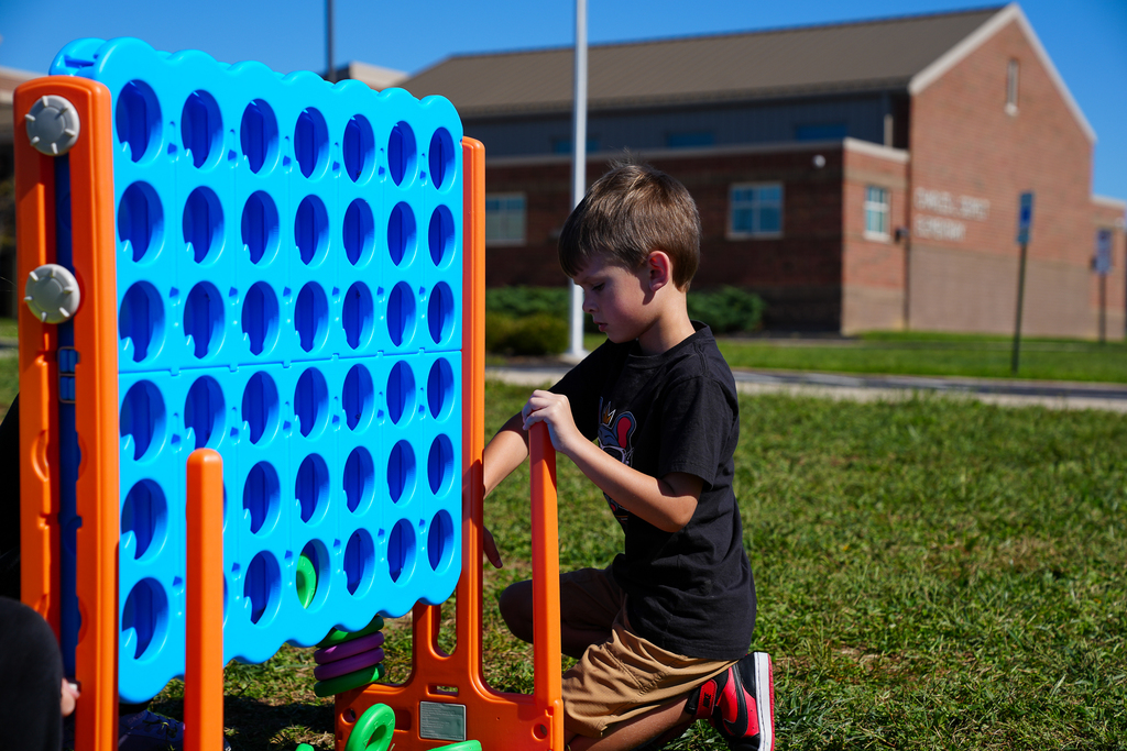 A boy about to play connect 4