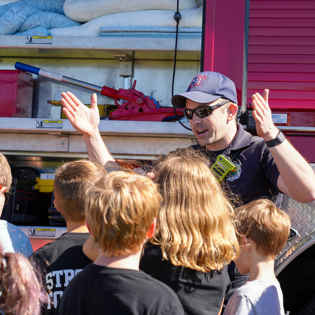 Firefighters explaining to kids his gear