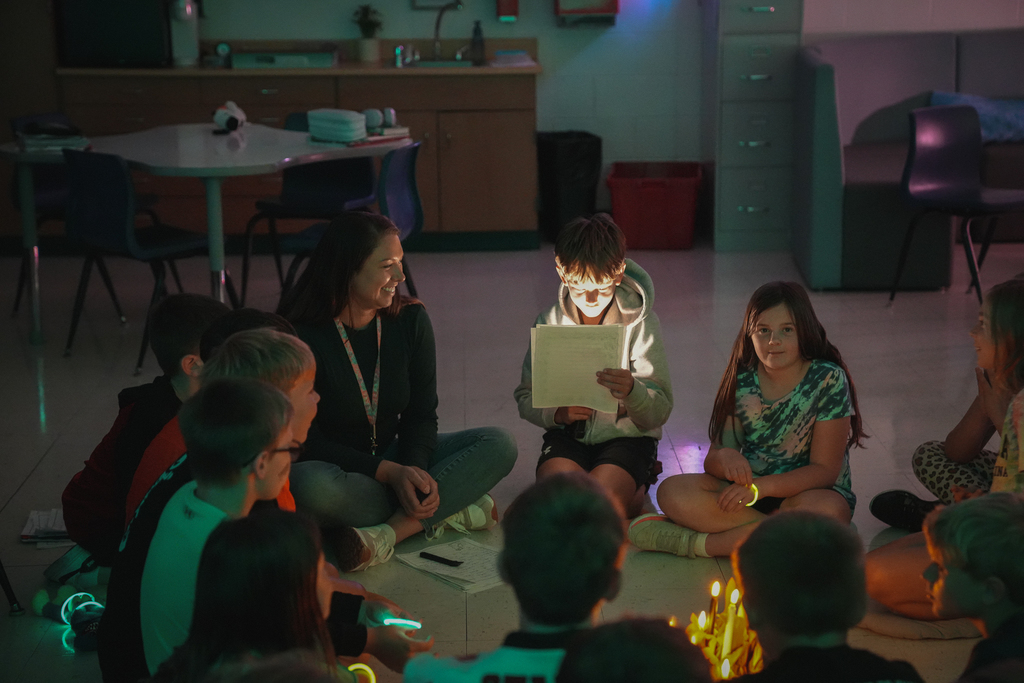 a circle of kids reading