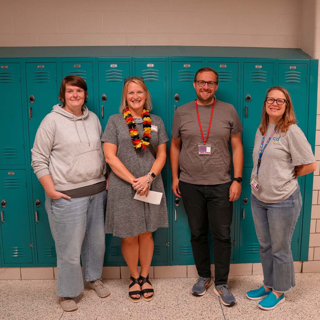 A group of teachers standing in front of lockers