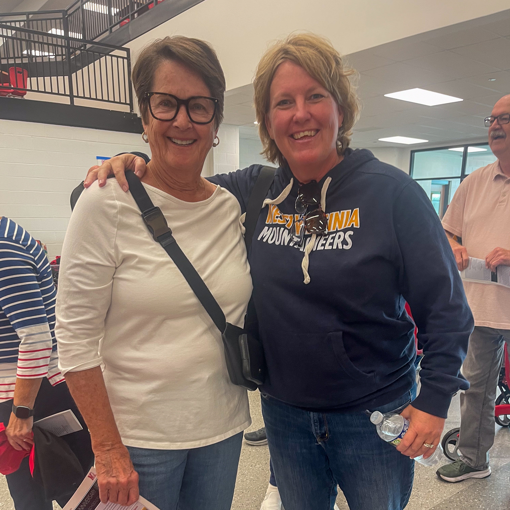 a senior woman in glasses next to a woman in a west virginia sweatshirt