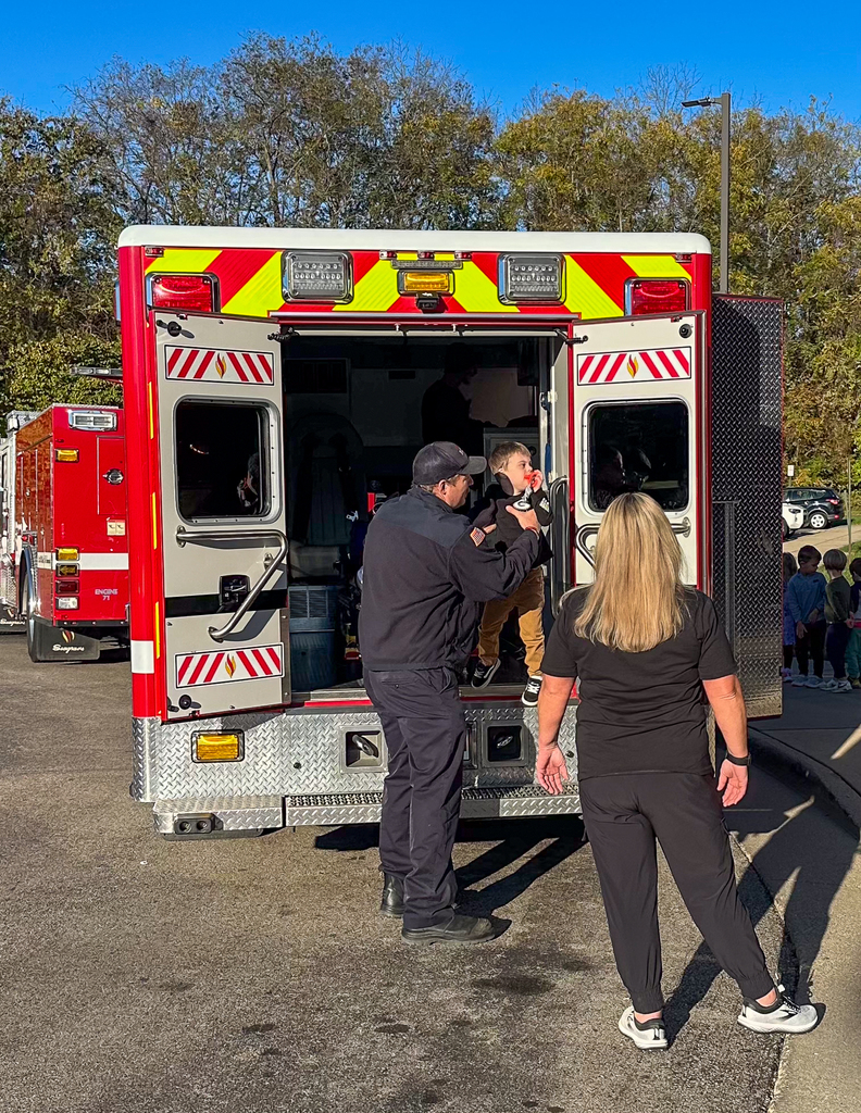 A Kindergartener getting off a firefighter ambulance