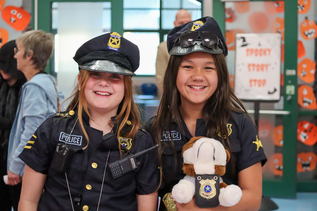Two girls dressed up like cops