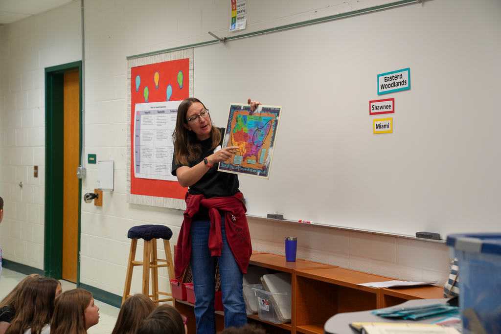 A woman pointing at a map