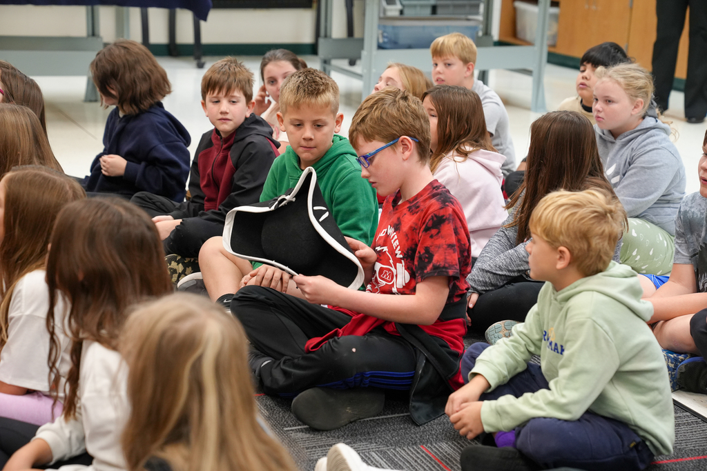 A boy examining an old hat