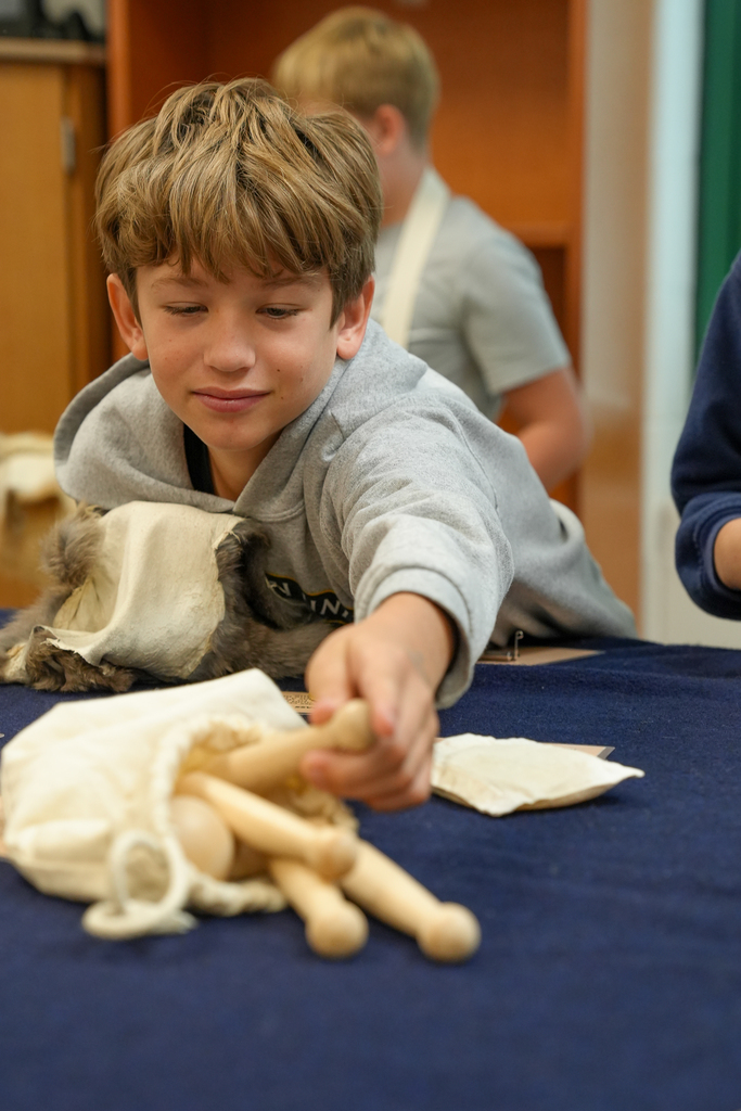 A boy reaching for a toy