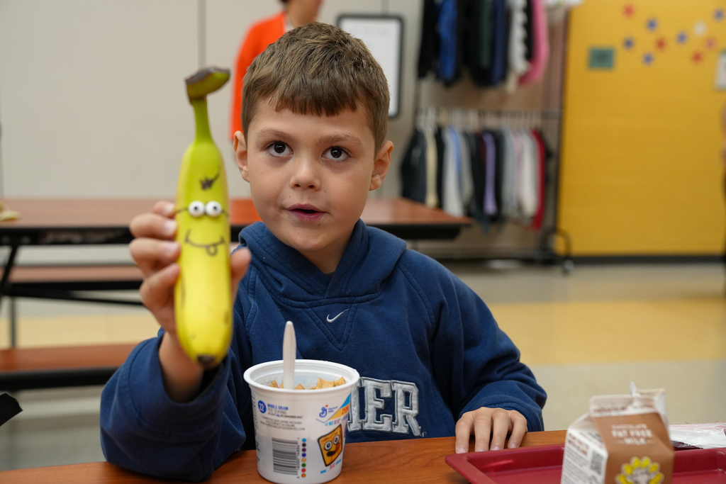 A student holding a banana
