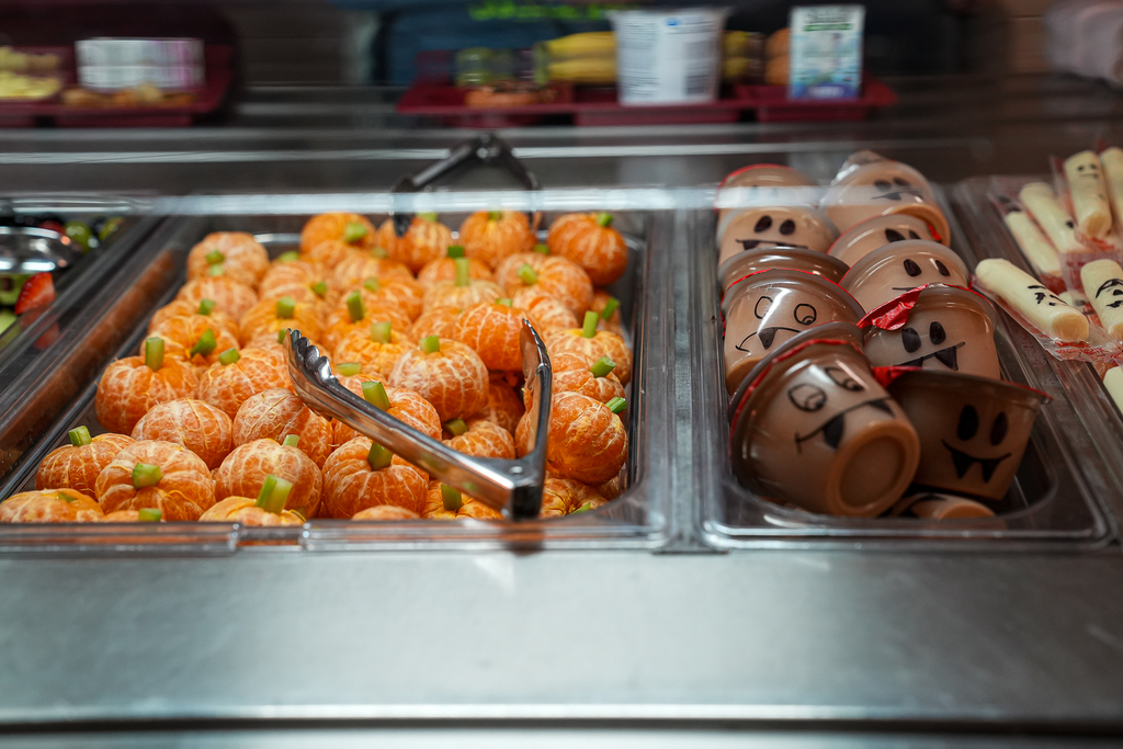 A thing of cuties and applesauce in a cafeteria line