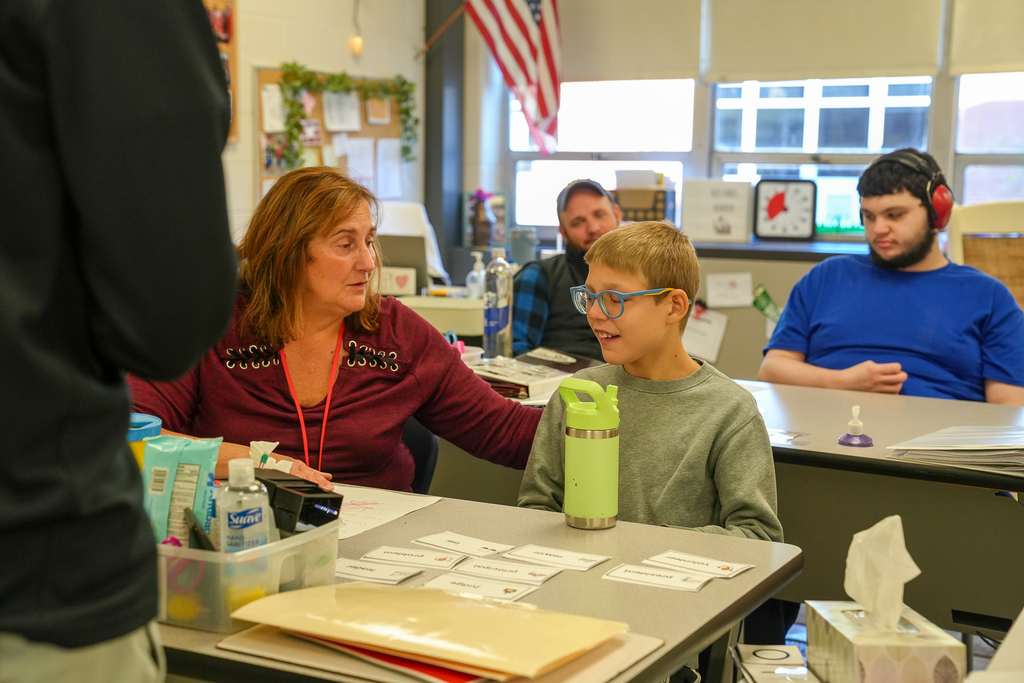 A student with glasses speaking 