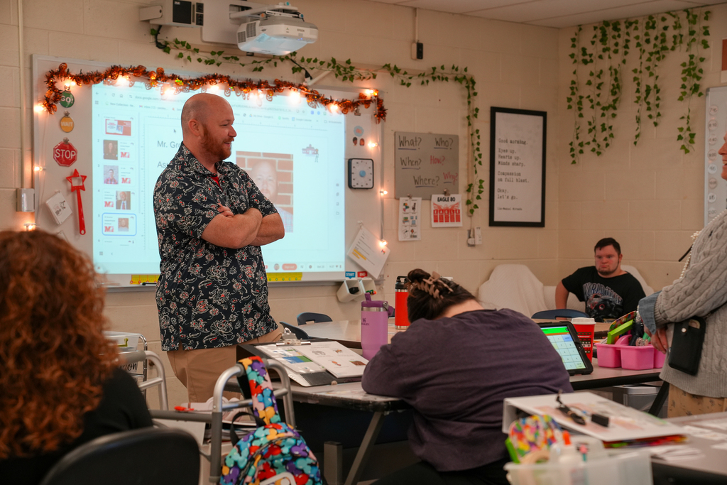 A bald man with a floral shirt