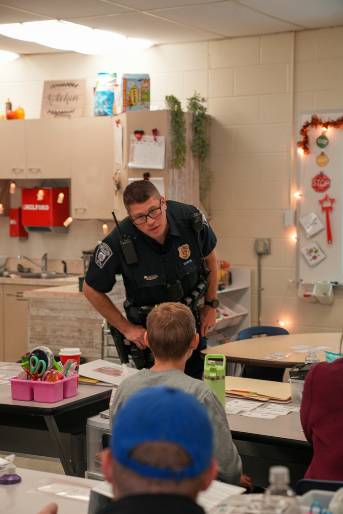 A police officer talking with a student