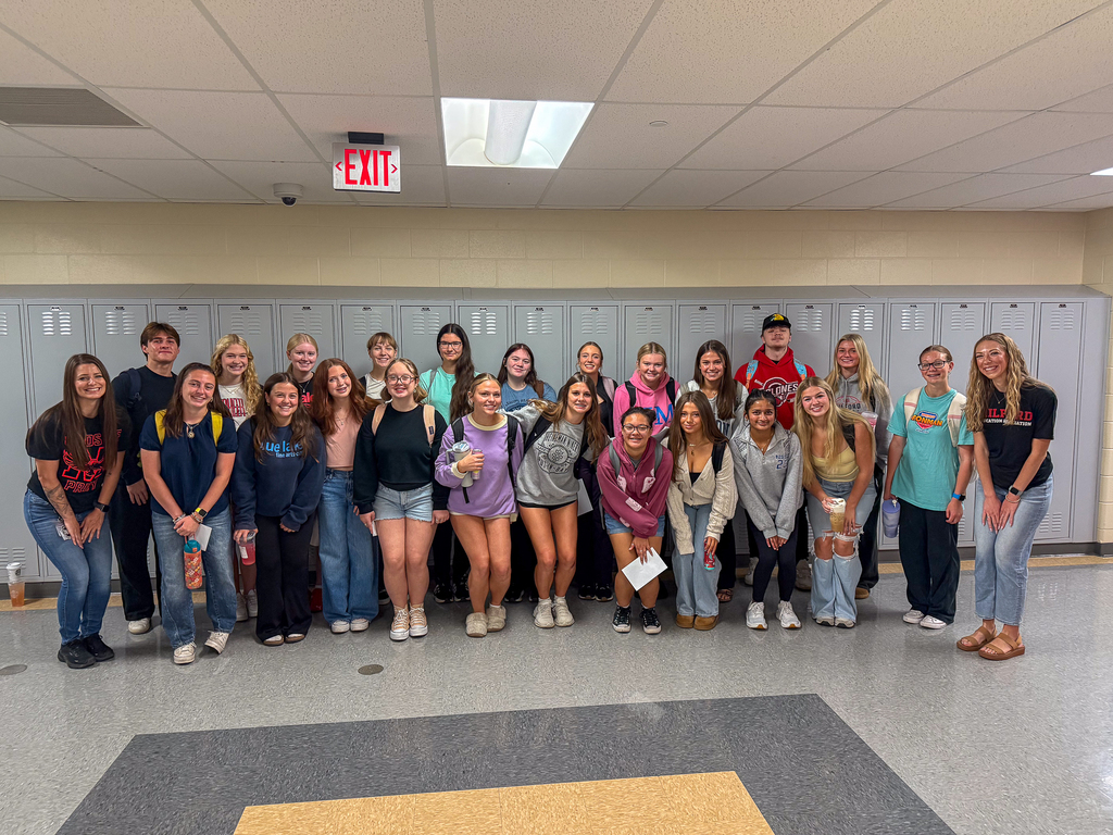 A group of kids standing in front of a locker 