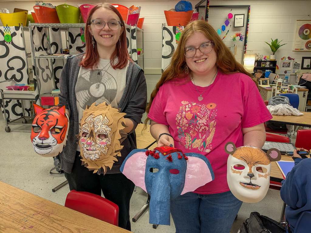 Student holding a mask