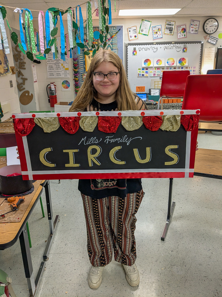 Student holding a mask