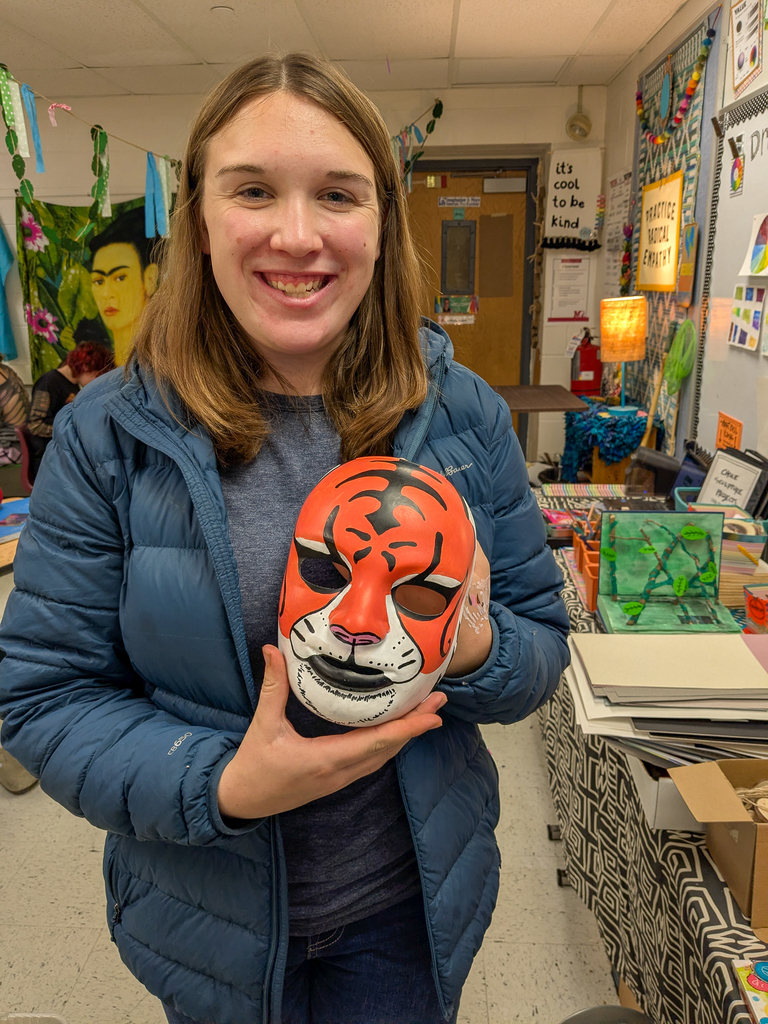 Student holding a mask