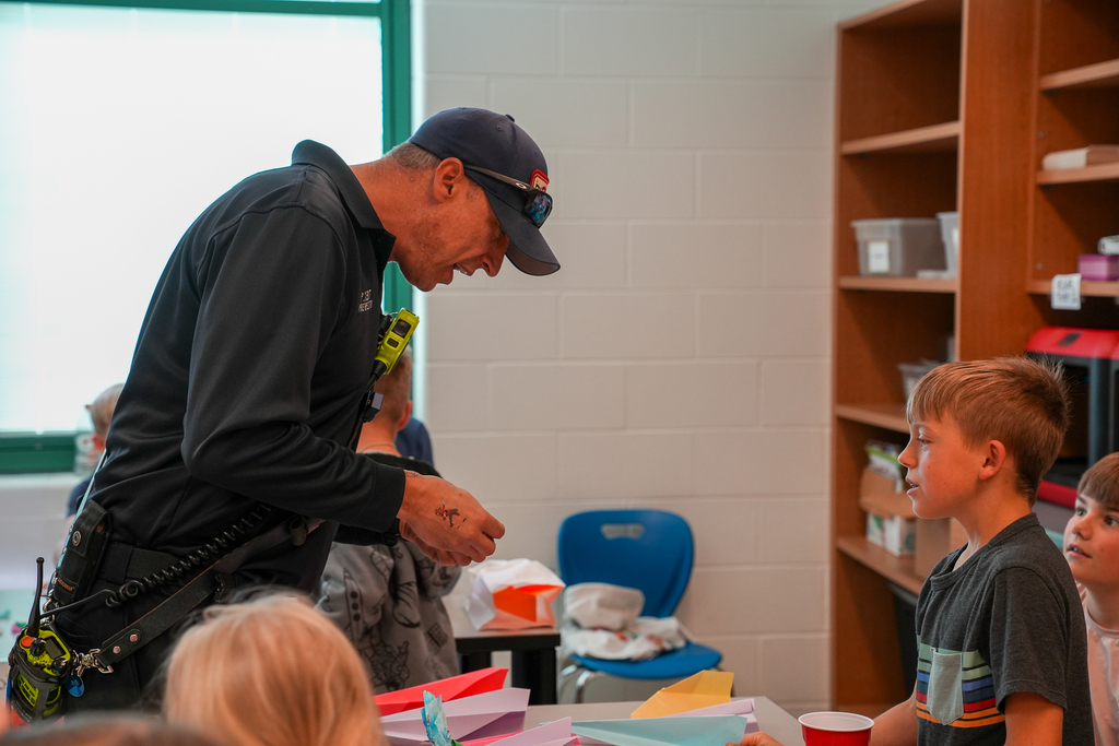 a fireman talking to a student