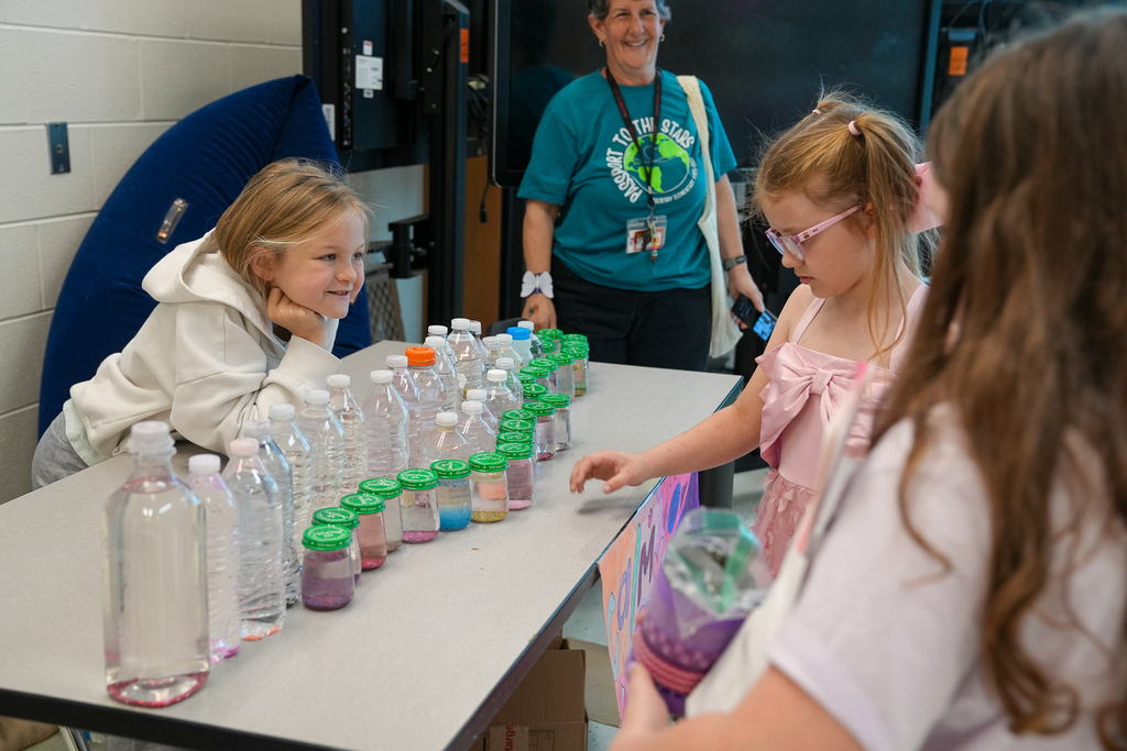 A student by waterbottles selling to other students