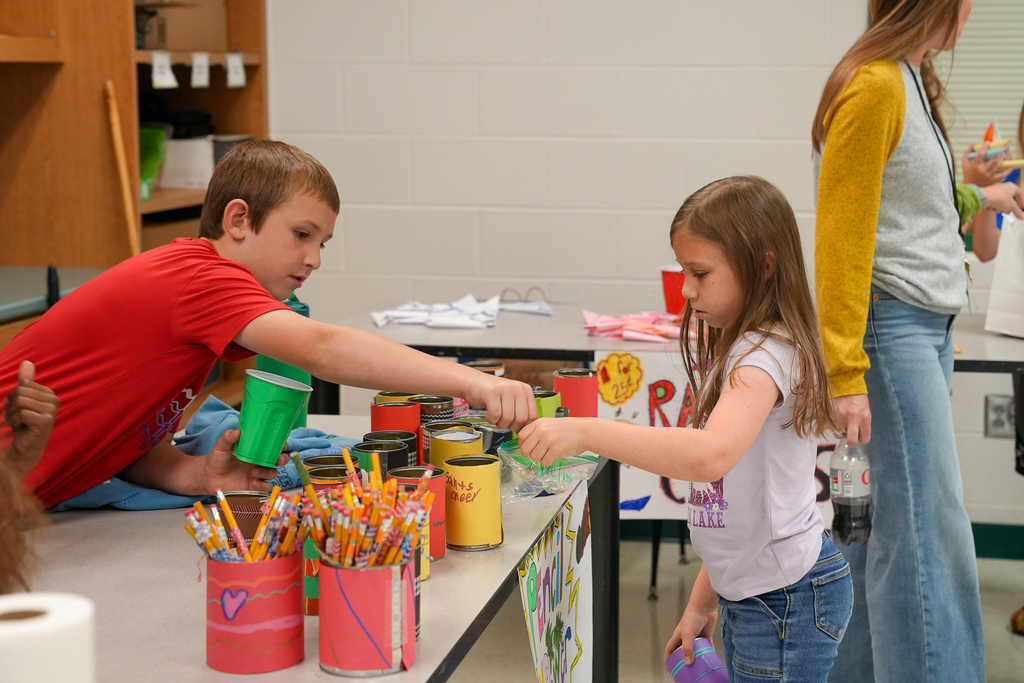 a student purchasing some cans