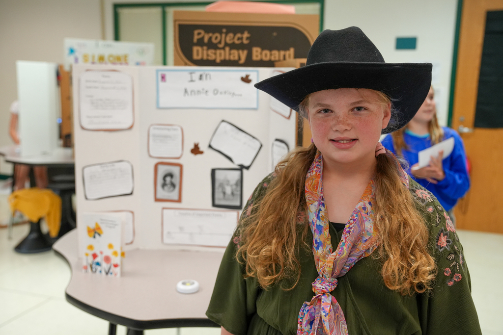 A girl dressed in a cowboy hat as Annie Oakley