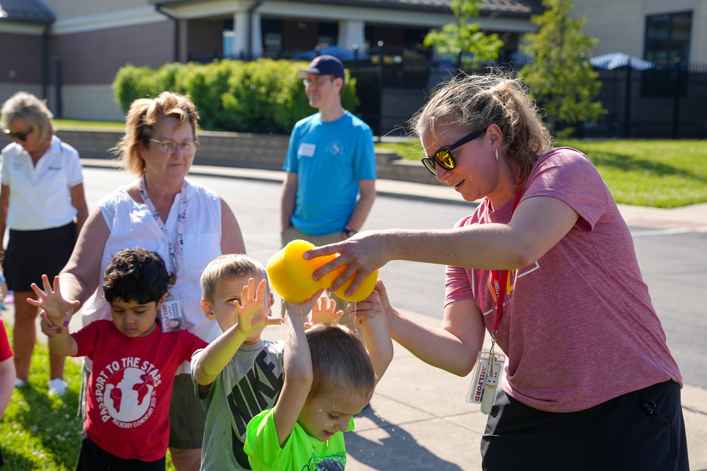 Milford preschool students getting wet from a sponge